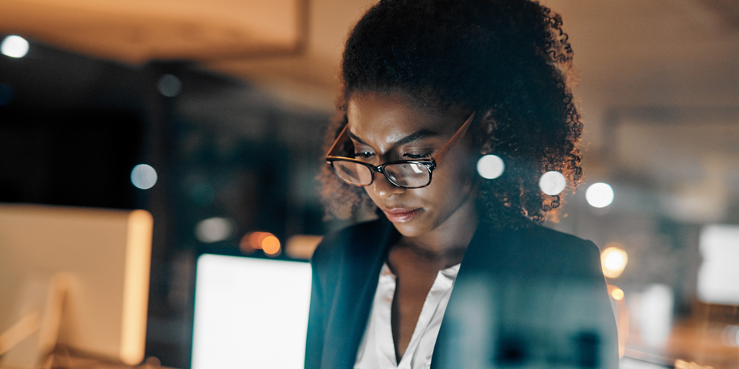 woman looking down at a computer